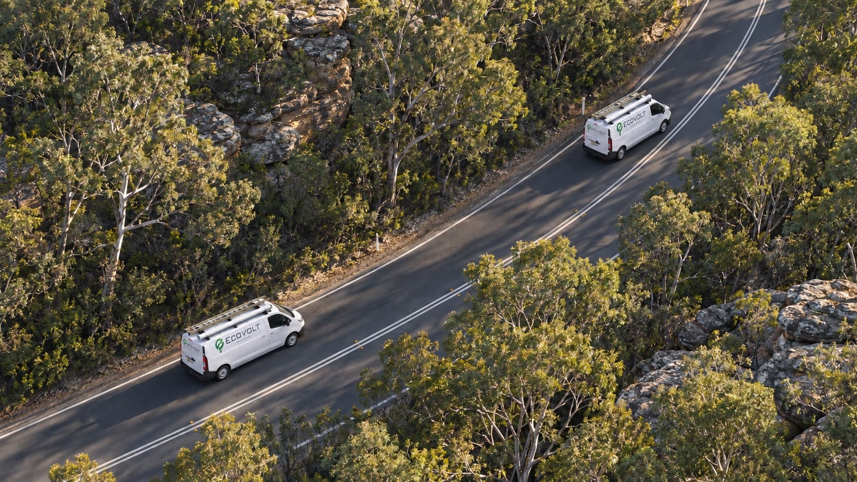 Two Ecovolt Electrical vans on a road through bushland