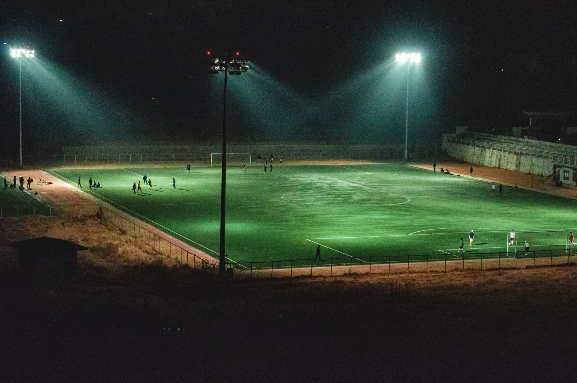 Sports field lit by floodlights at night